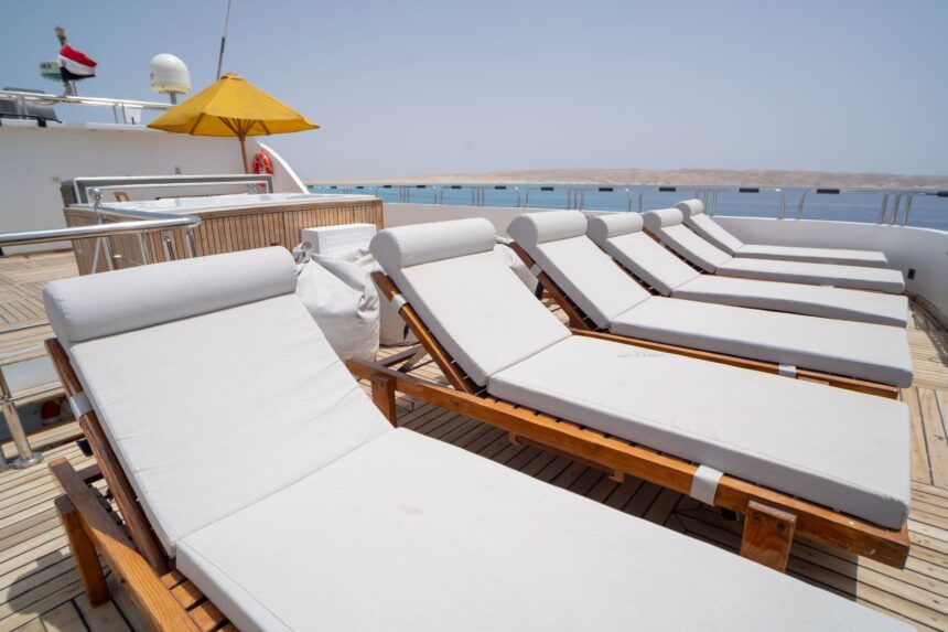Rows of white sun loungers on the Captain Sparrow's deck under a clear sky