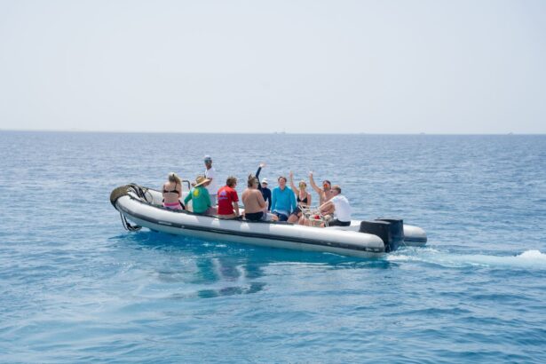 Group of divers riding a RIB tender boat waving toward the camera