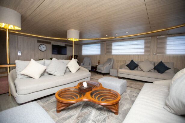Living room lounge with curved sofas and a wooden coffee table aboard the Captain Sparrow
