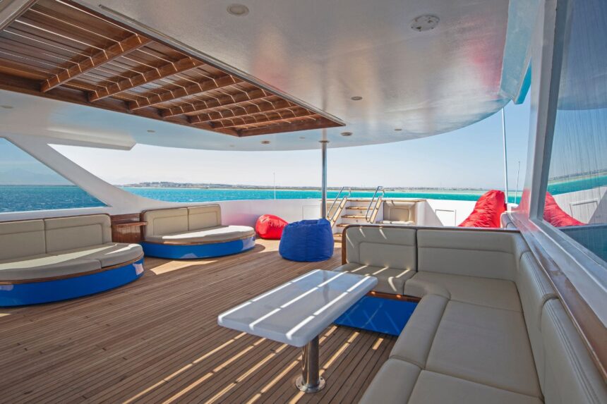 Shaded lounge area on the Dolce Vita's deck with blue cushioned daybeds