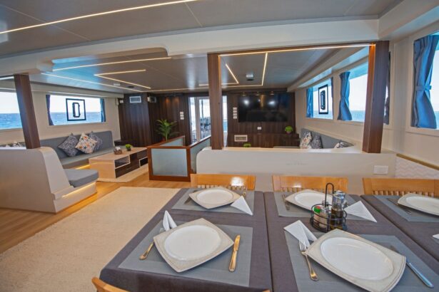 Salon on the Dolce Vita with grey sofas facing a wall-mounted TV and dining table