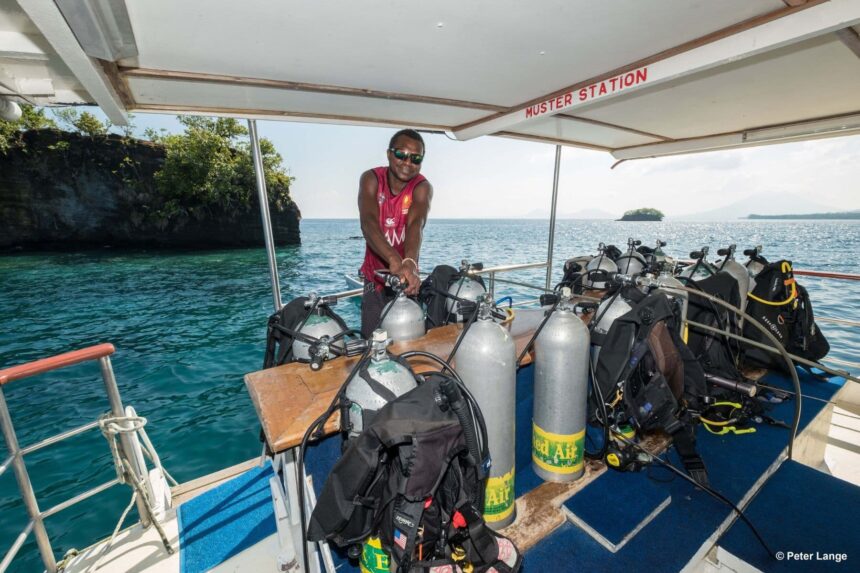 MV FeBrina crew member arranging scuba tanks at the boat's muster station