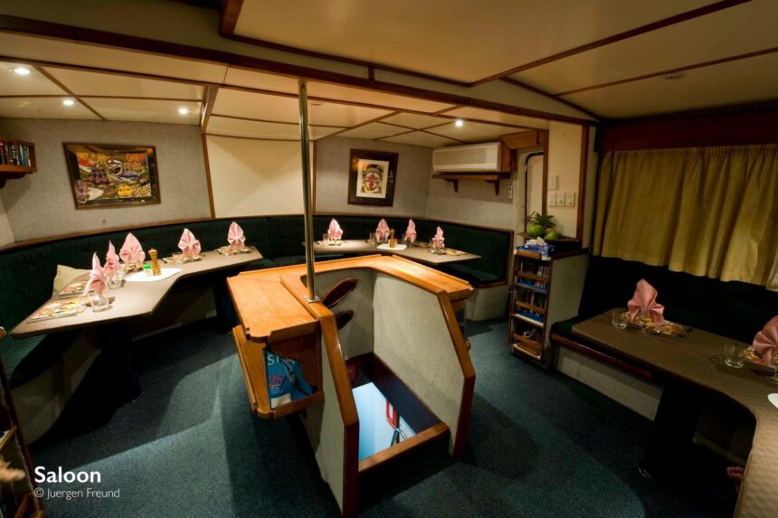 Dining saloon aboard the MV FeBrina set with pink napkins and bar seating