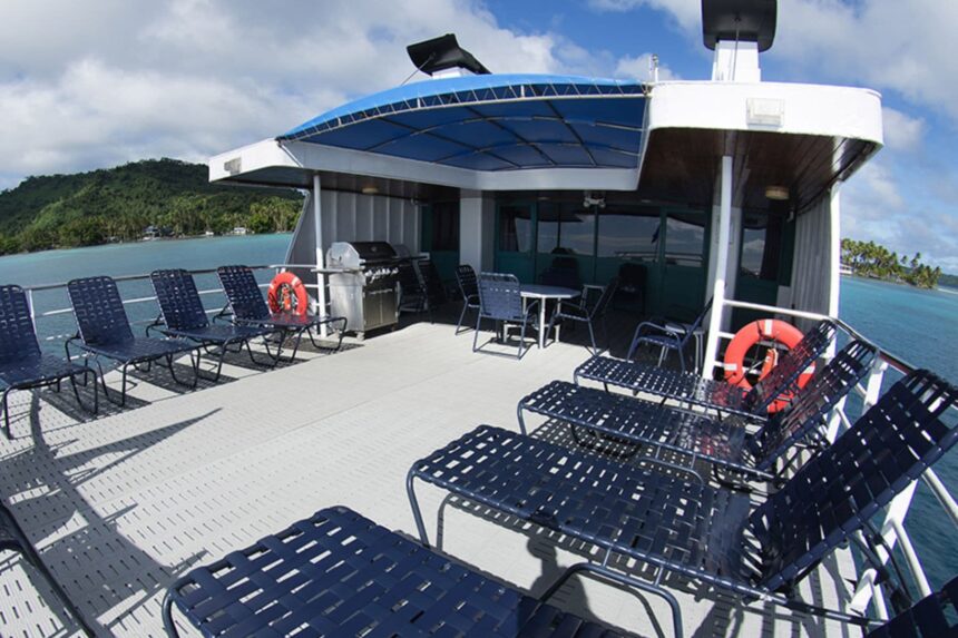 Sun deck loungers and a barbecue grill on the Odyssey liveaboard's top deck