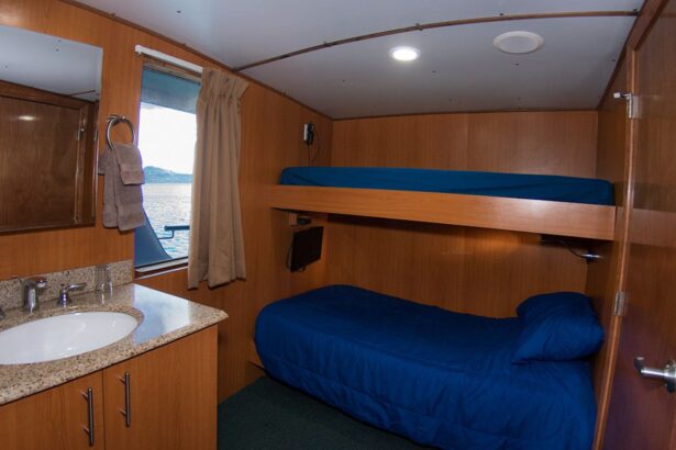Bunk cabin with an ensuite bathroom and window aboard the Odyssey liveaboard