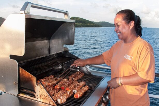 Crew member grilling skewers on deck aboard the Odyssey liveaboard