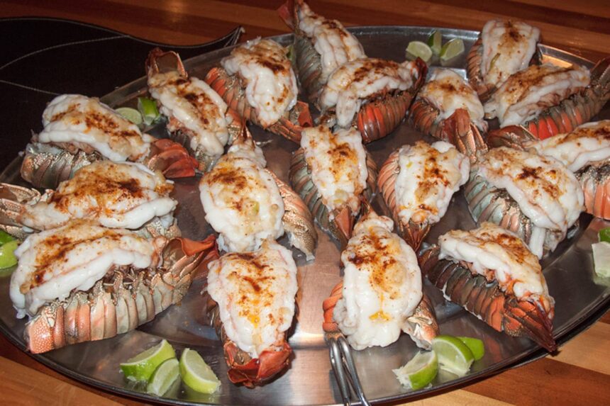 Platter of grilled lobster tails with lime wedges served aboard the Odyssey liveaboard