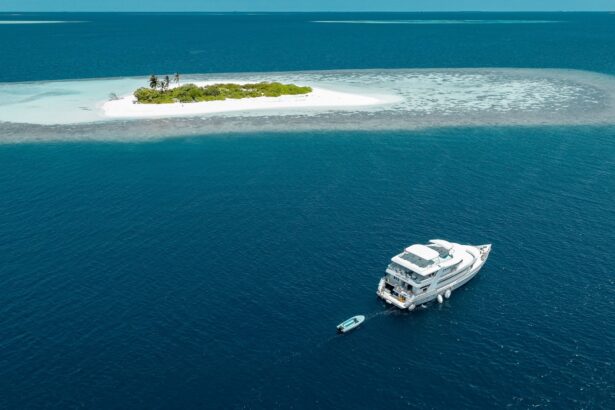 Aerial view of the Amba liveaboard anchored beside a small sandy island