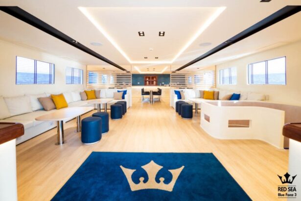 Indoor lounge aboard the Blue Force 3 with a navy rug bearing the Red Sea crown logo