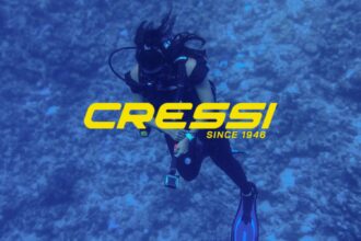 Scuba diver in black gear over a reef, overlaid with the Cressi since 1946 logo