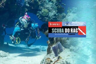 Scuba diver swimming past a coral archway with a ScubaDoRag banner ad overlaid on the image