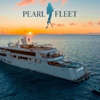 Pearl Fleet liveaboard superyacht anchored at sunset with tender boats alongside