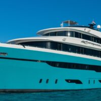 The liveaboard yacht Turquoise, with a bright turquoise hull, sitting on calm blue Red Sea water