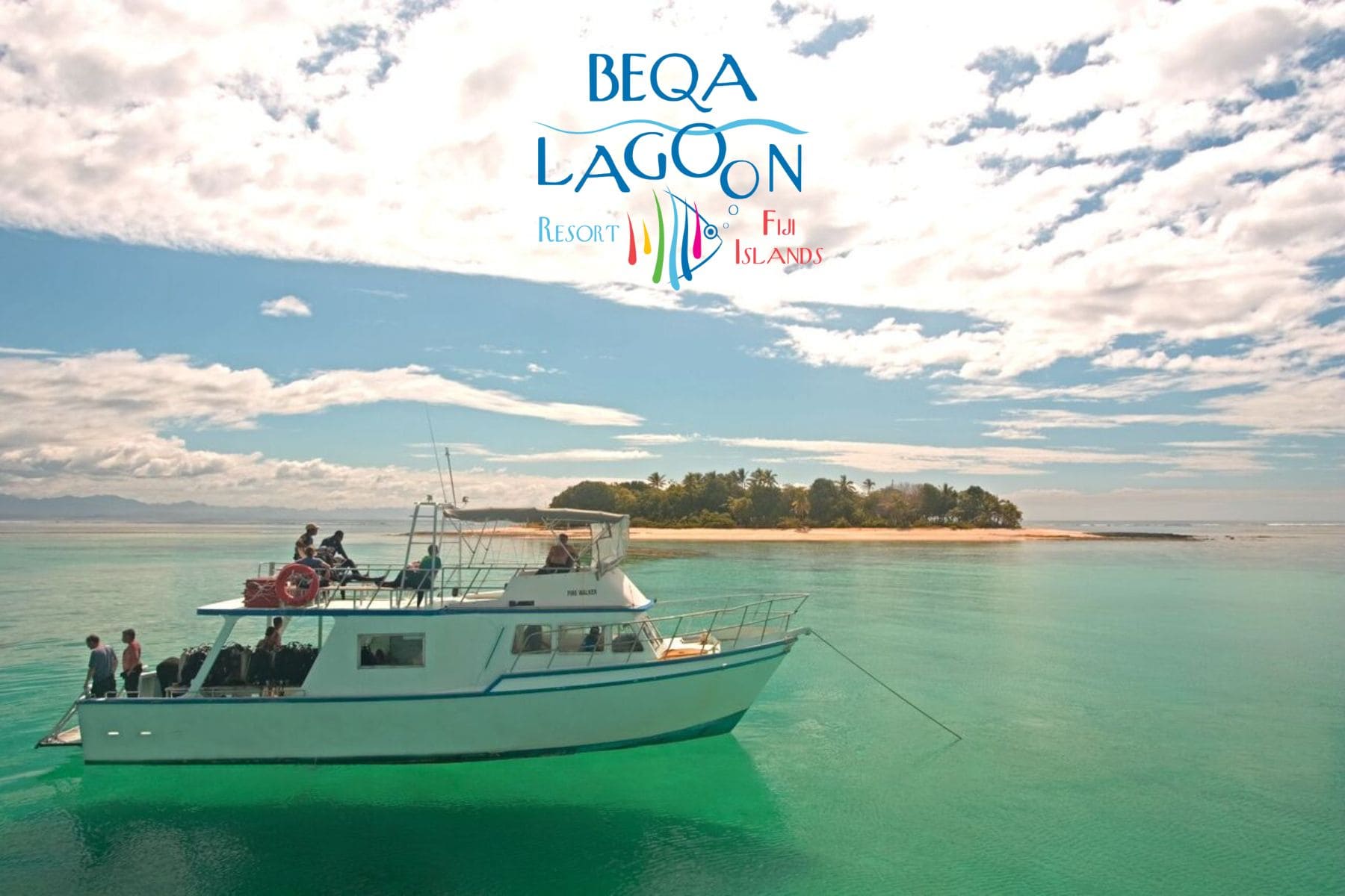 Dive boat carrying divers anchored off a small island at Beqa Lagoon Resort in Fiji