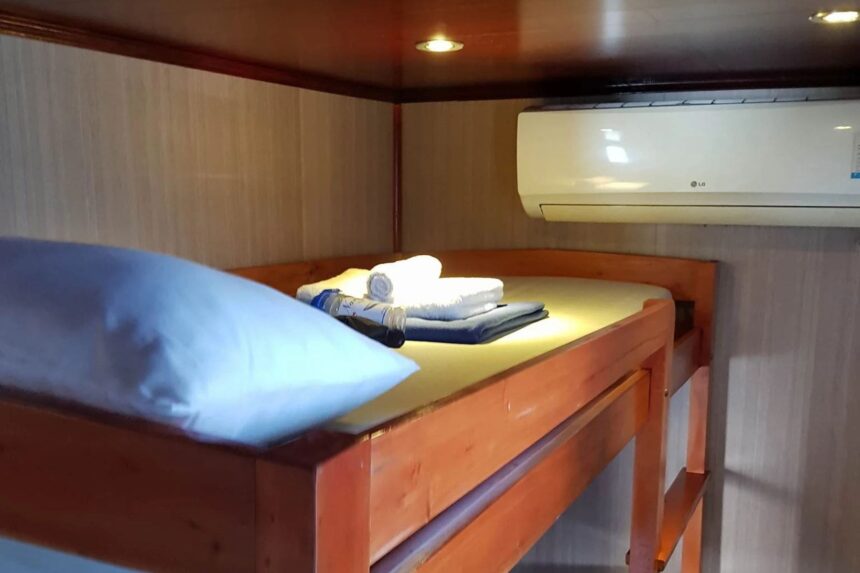 bunk bed cabin with an air conditioning unit mounted on the wall