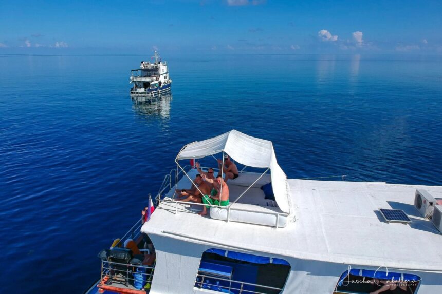 aerial view of divers relaxing on the shaded top deck of a liveaboard