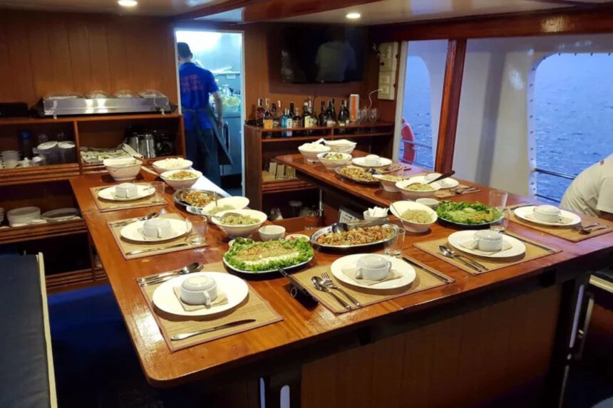 long dining table spread with rice, salads, and cooked dishes