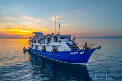 Narayana liveaboard dive boat anchored at sunset with crew on deck