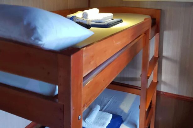 wooden bunk bed with folded towels and a pillow