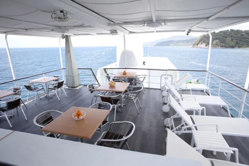 Outdoor dining tables set on the deck of Stella Maris Explorer