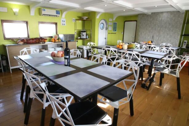 Indoor dining room aboard Stella Maris Explorer set with fruit and wine