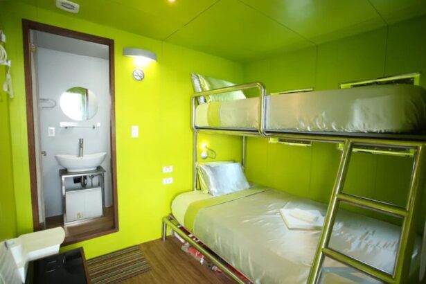 Green bunk cabin aboard Stella Maris Explorer with an ensuite bathroom