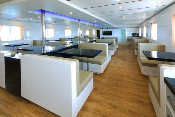 booth seating and dark tables inside the dining lounge aboard Discovery Palawan