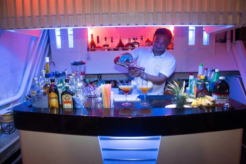 bartender mixing tropical cocktails at the bar on Discovery Palawan