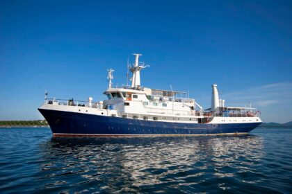 Discovery Palawan liveaboard dive boat viewed from the side on calm water