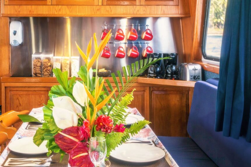galley counter with hanging mugs and coffee makers aboard Atlantis Adventurer