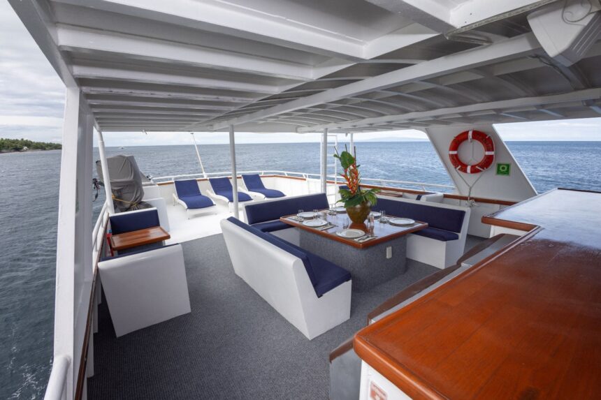 shaded sundeck lounge and dining area aboard Atlantis Adventurer