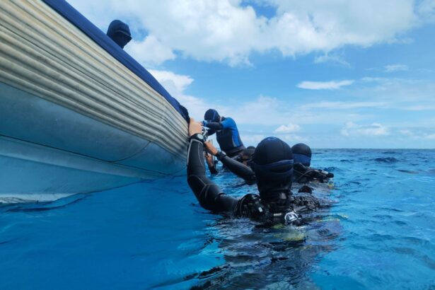 divers rolling off a tender boat into the water