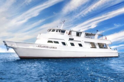 Atlantis Azores liveaboard dive boat cruising under a wispy blue sky