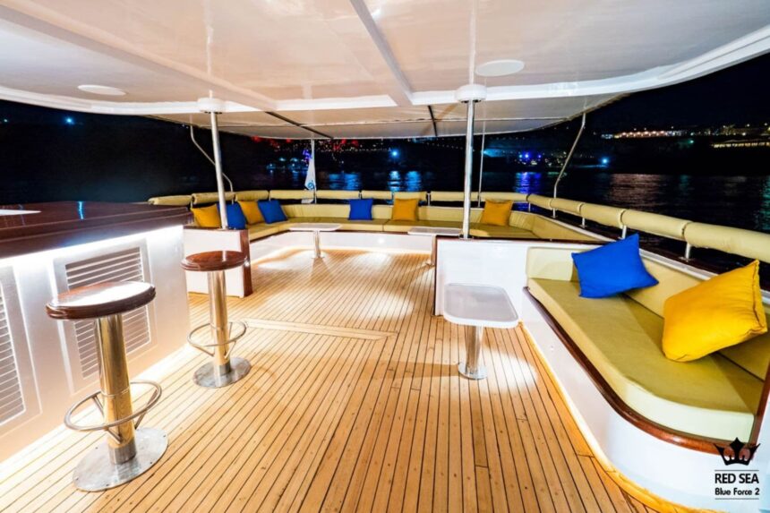 cushioned lounge seating on Red Sea Blue Force 2's sundeck lit up at night
