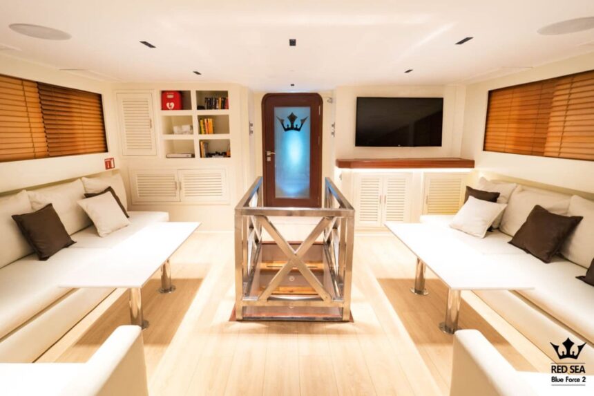 indoor salon lounge aboard Red Sea Blue Force 2 with bookshelf and TV