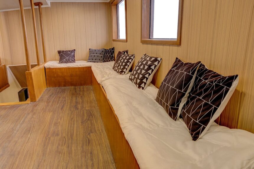 A cabin bench seat piled with patterned pillows aboard the M/Y Resolute