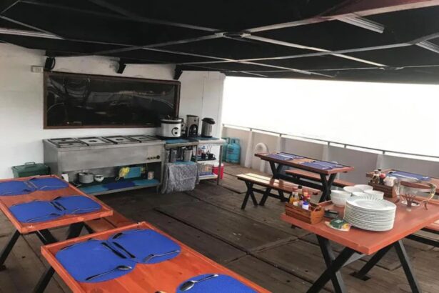 Outdoor dining tables set up under a canopy aboard the M/Y Resolute