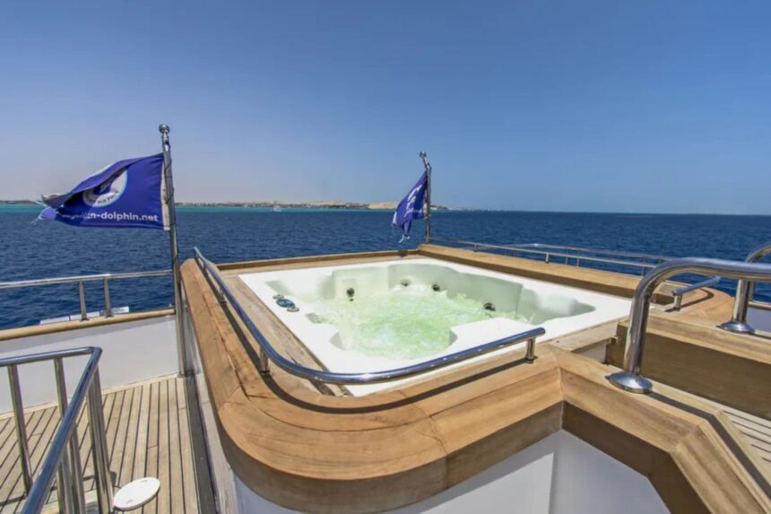 Sun loungers near the mast on the Golden Dolphin IV's upper deck
