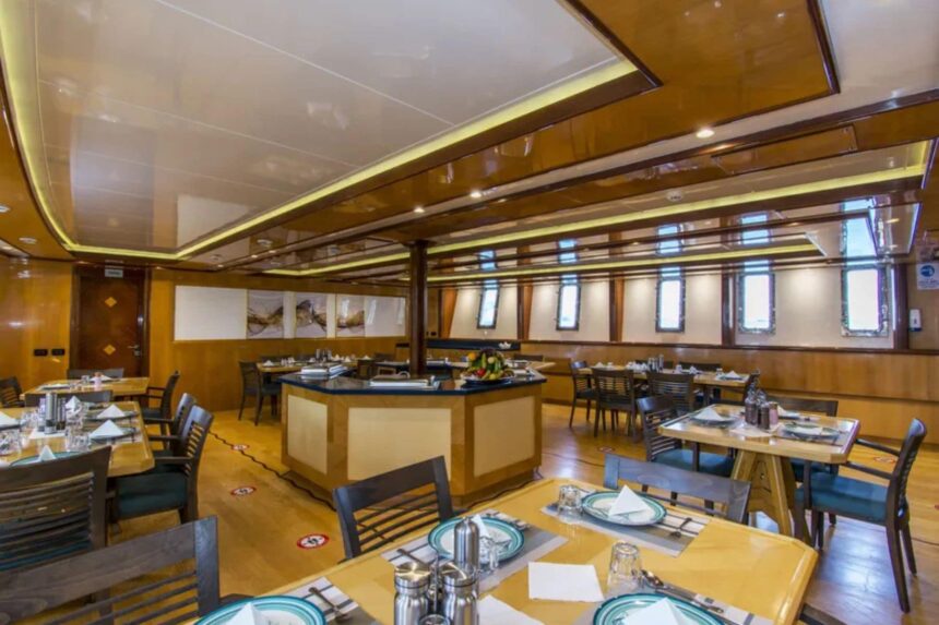 Blue sofas and a round table in the Golden Dolphin IV salon