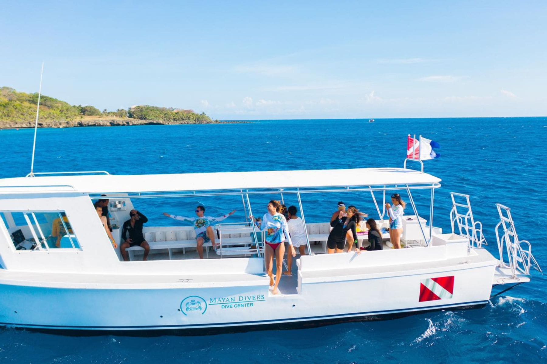 Divers relaxing aboard a Mayan Divers dive boat near Roatan's coastline