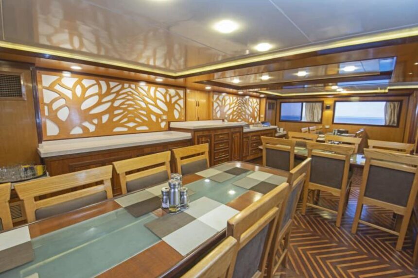 Wood-paneled dining saloon aboard the Golden Dolphin II liveaboard