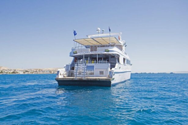 The Golden Dolphin II liveaboard anchored at sea, viewed from the stern