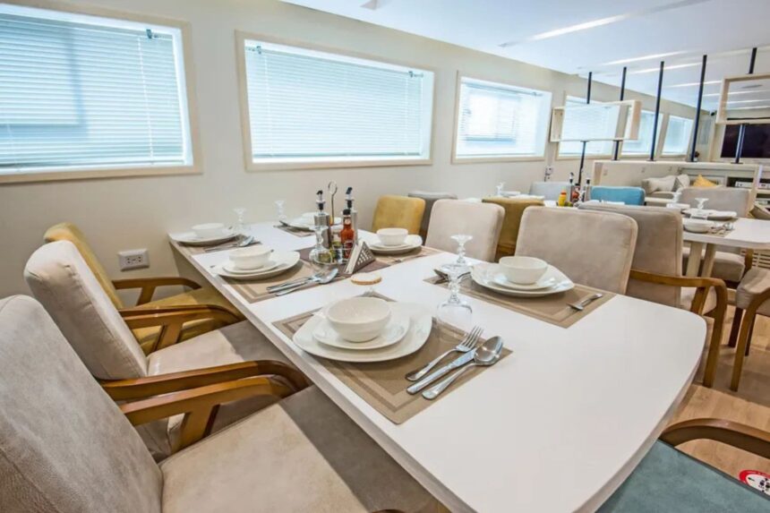 Dining room with white table settings aboard the SS Glorious Miss Nouran liveaboard