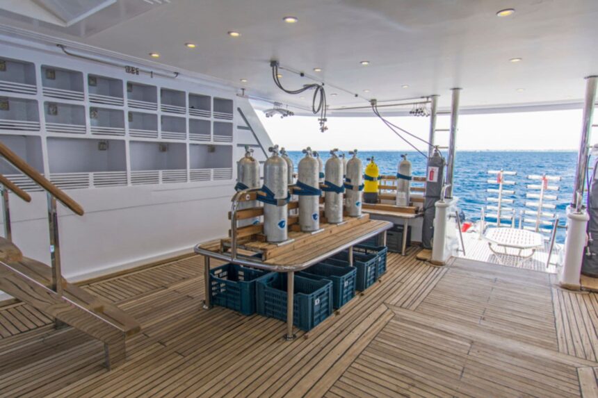 scuba tanks stored in wooden racks on the Golden Dolphin III dive deck