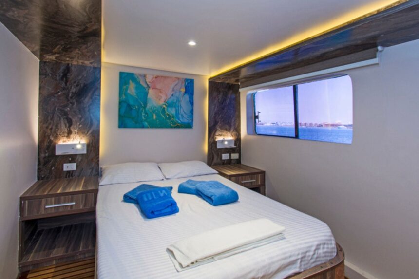 twin cabin aboard the Golden Dolphin III with a large ocean-view window