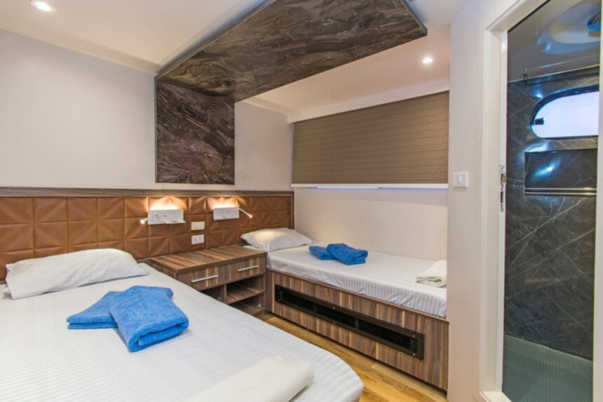 twin cabin aboard the Golden Dolphin III with dark marble accents