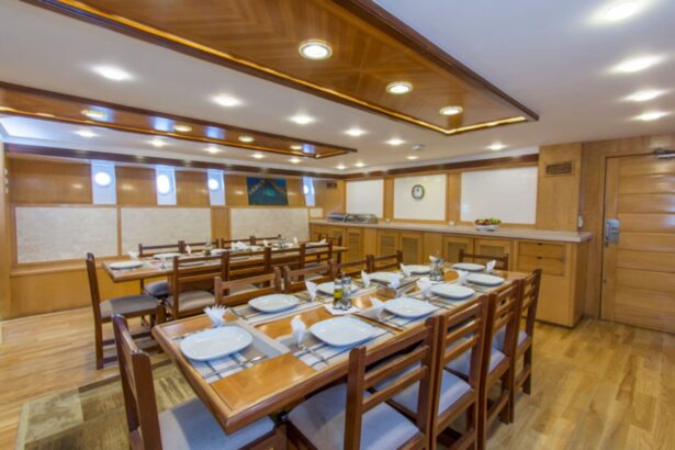wood-paneled dining room with tables set for guests aboard the Golden Dolphin III