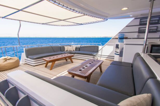 outdoor lounge with gray sofas and a coffee table on the Golden Dolphin III's upper deck