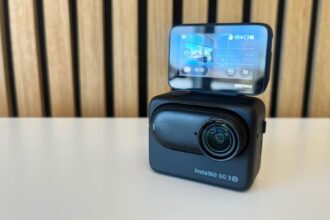Insta360 GO 3S camera seated in its Action Pod with the flip up touchscreen raised