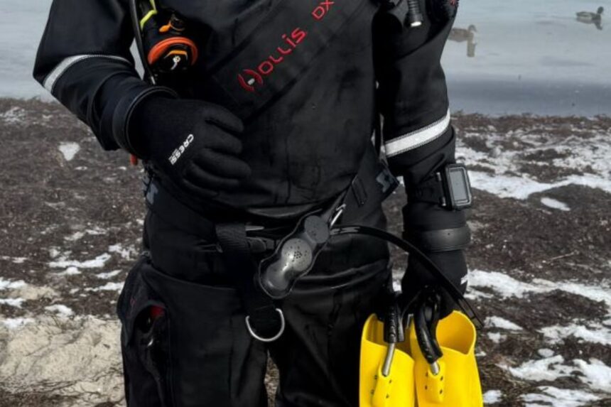 Hollis DX-300X Wrist Seal And Glove DIVEIN tester checking the wrist seal and glove cuff on the Hollis DX-300X drysuit at a snowy shoreline